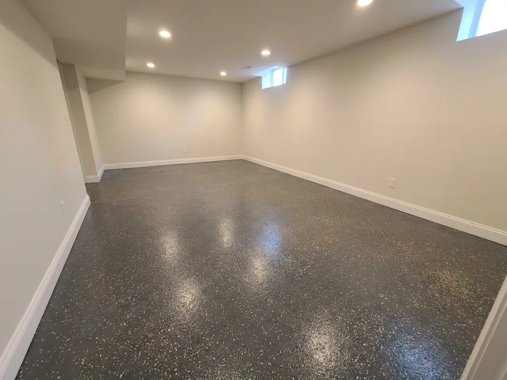 Coated basement floor with a charcoal flake finish