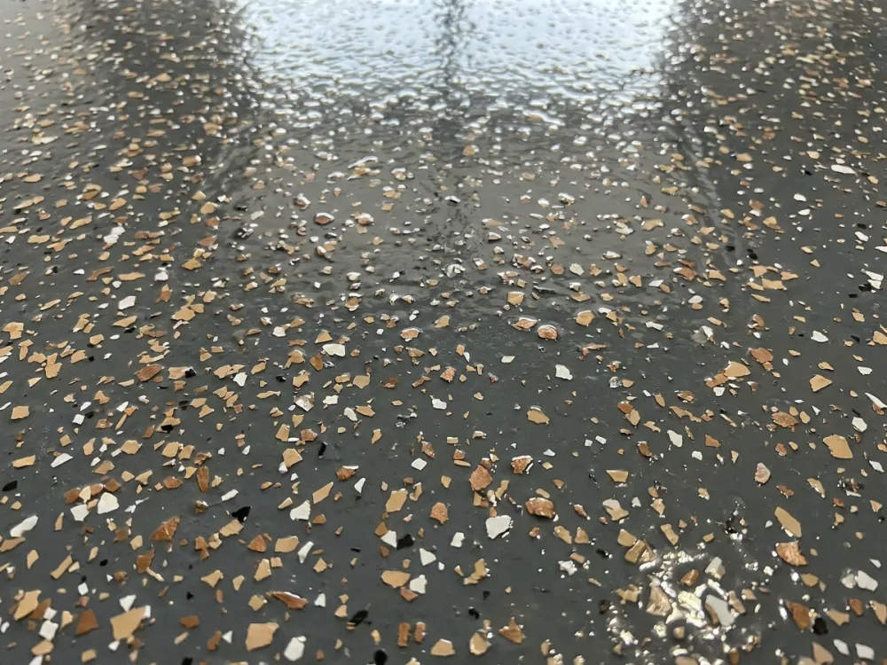 Close-up of the epoxy-flake floor texture - charcoal, tan and white