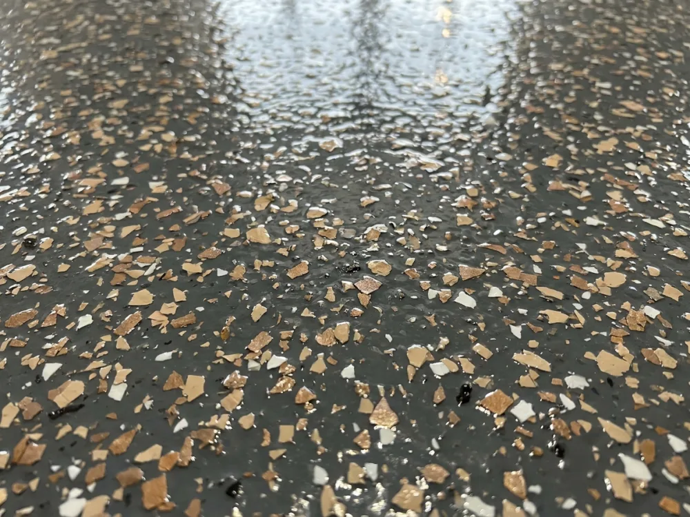 Glossy polyaspartic topcoat over decorative flake, close up